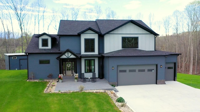 view of front of property featuring a garage and a front lawn