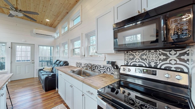 kitchen with stainless steel electric stove and white cabinets