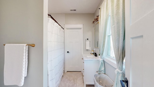 bathroom featuring tile patterned flooring and vanity