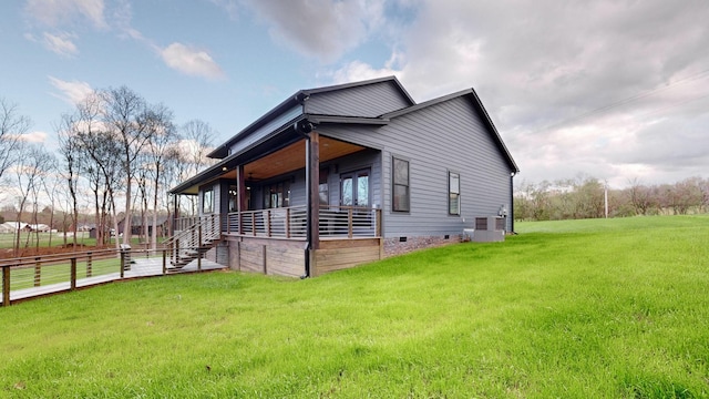 view of side of home with a yard and cooling unit