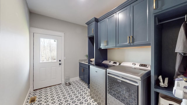 laundry area with washer and dryer and cabinets