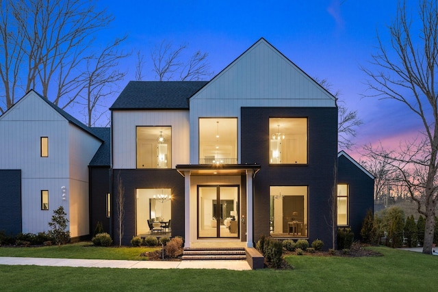 modern farmhouse style home with a lawn