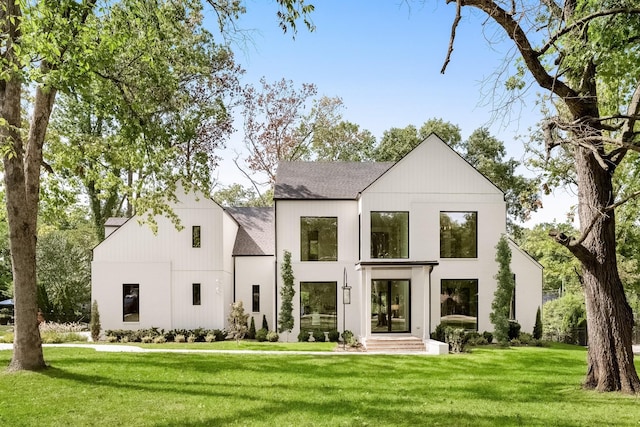 rear view of property with a yard