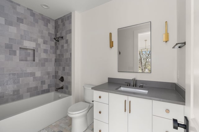 full bathroom with vanity, toilet, and tiled shower / bath