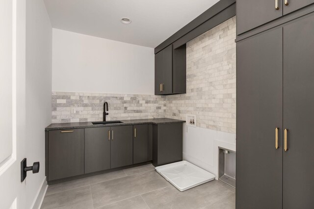 interior space with sink, hookup for a washing machine, and cabinets