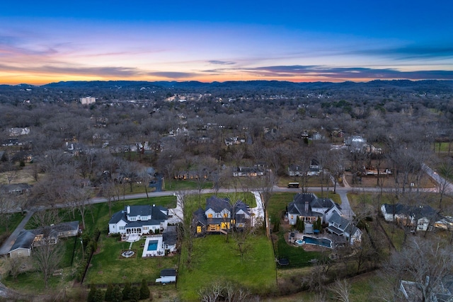 aerial view at dusk featuring a mountain view