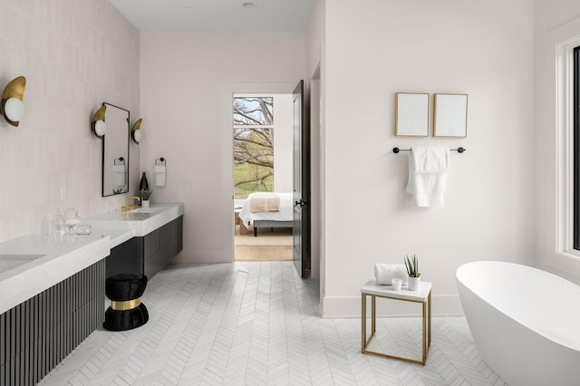 bathroom featuring tile patterned flooring, vanity, and a bathing tub