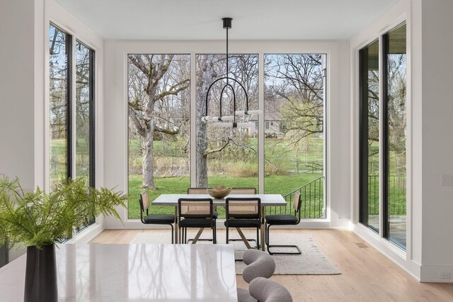 sunroom / solarium featuring a healthy amount of sunlight