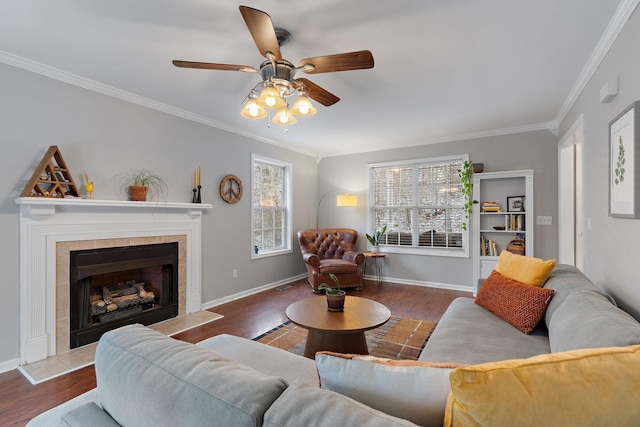 living room featuring a fireplace, hardwood / wood-style floors, ceiling fan, and ornamental molding