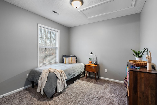 carpeted bedroom featuring a textured ceiling