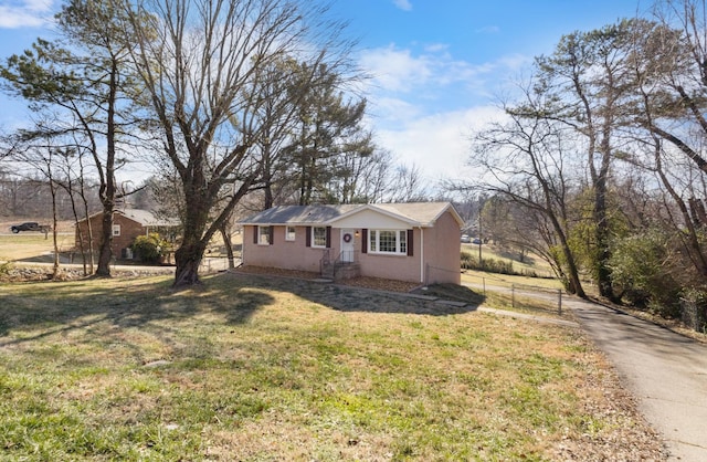 ranch-style home with a front lawn