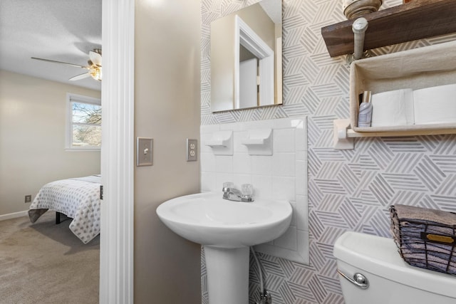 bathroom with ceiling fan and toilet