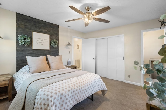 bedroom featuring ceiling fan, carpet, and a closet