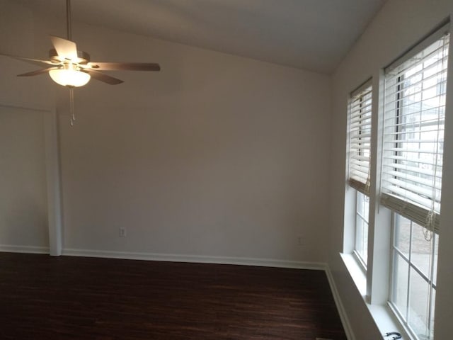 spare room featuring ceiling fan, dark hardwood / wood-style floors, lofted ceiling, and a wealth of natural light