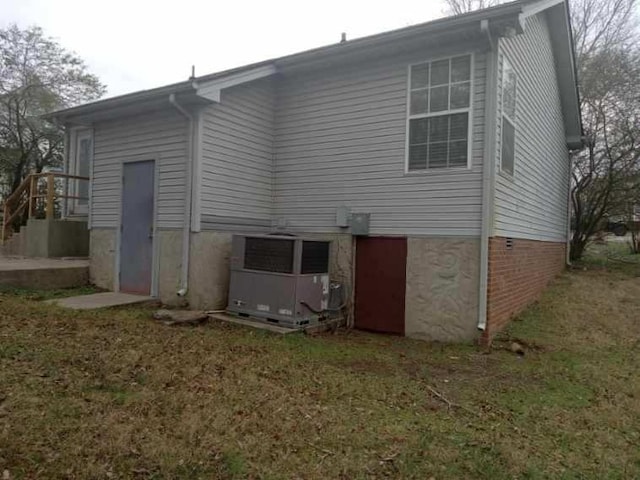 back of house with a yard and cooling unit