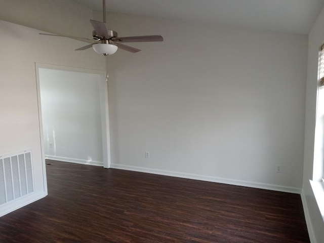 spare room featuring ceiling fan, dark wood-type flooring, and lofted ceiling