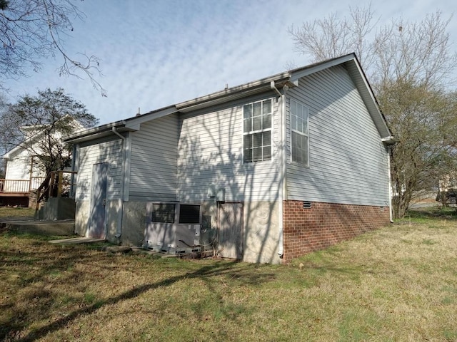 view of property exterior with a yard and central AC