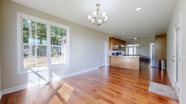 kitchen featuring kitchen peninsula, a wealth of natural light, and hanging light fixtures