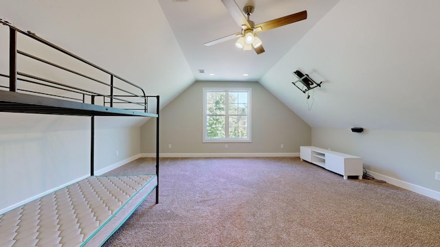 unfurnished bedroom featuring ceiling fan, carpet floors, and vaulted ceiling