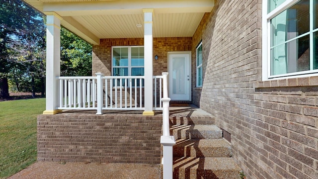 view of exterior entry with a porch