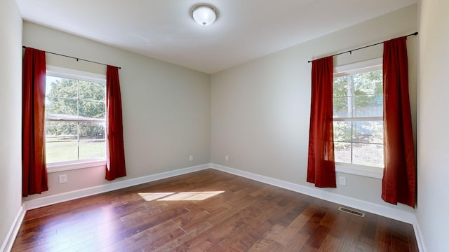 spare room featuring dark hardwood / wood-style flooring