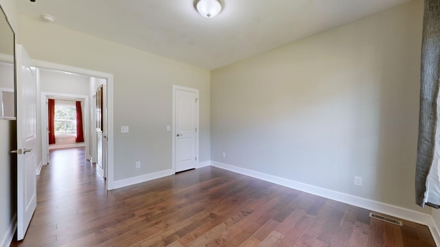 unfurnished bedroom with dark hardwood / wood-style flooring