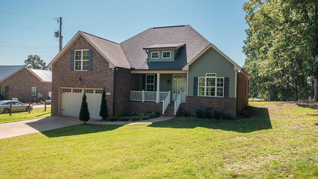 view of front of house featuring a porch, a front yard, and a garage