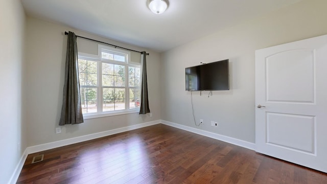 empty room with dark hardwood / wood-style floors