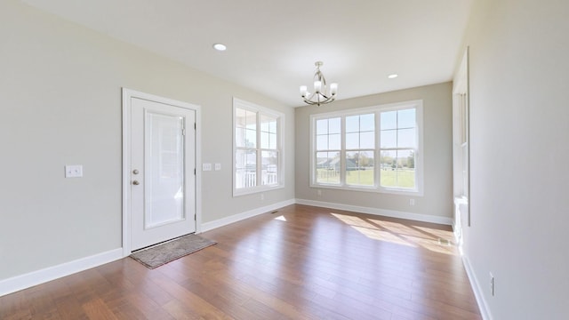 interior space with a chandelier and hardwood / wood-style flooring