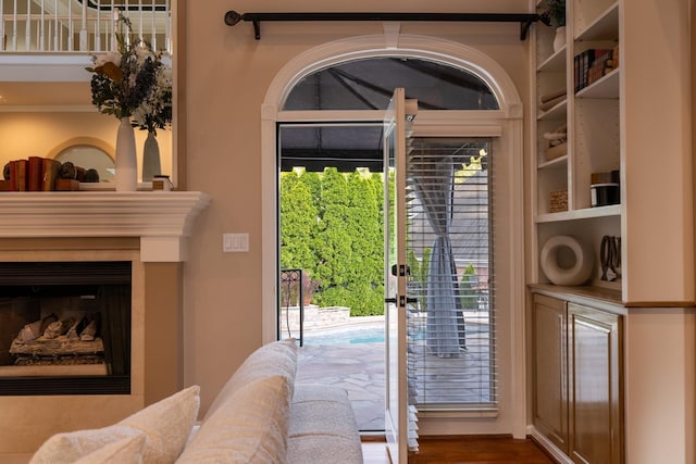 doorway to outside featuring a fireplace and hardwood / wood-style floors