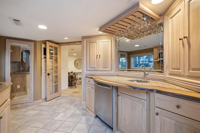 kitchen with light brown cabinets, light tile patterned floors, sink, and stainless steel appliances