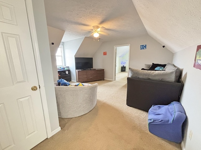 living room with carpet, a textured ceiling, ceiling fan, and lofted ceiling