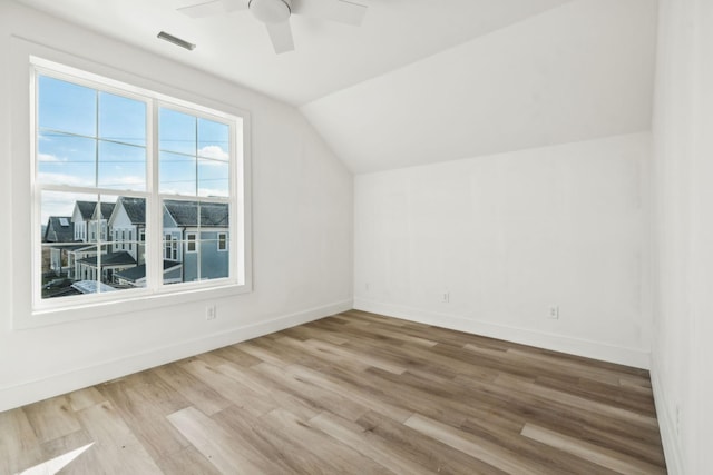 additional living space with wood-type flooring, ceiling fan, and lofted ceiling