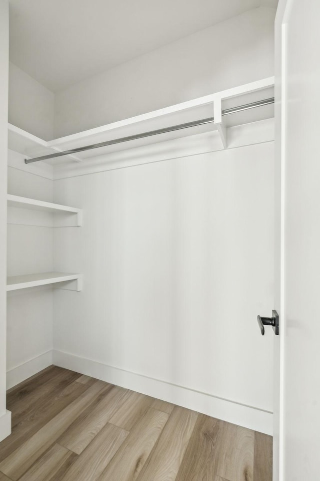 walk in closet featuring hardwood / wood-style floors