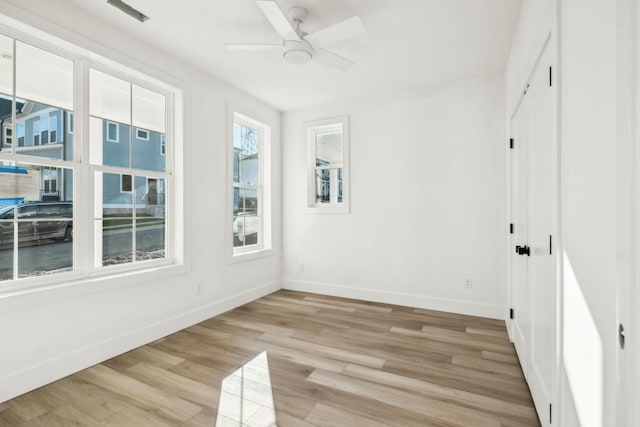 unfurnished room with ceiling fan and light wood-type flooring