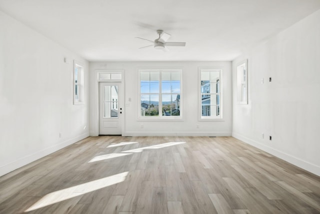 unfurnished living room with ceiling fan and light hardwood / wood-style flooring