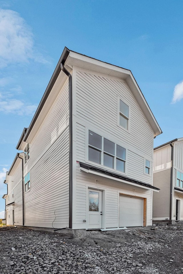 rear view of property with a garage