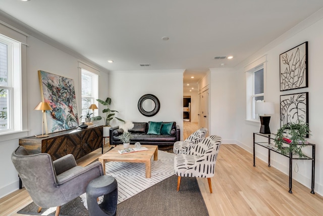 living area featuring recessed lighting, baseboards, light wood finished floors, and ornamental molding