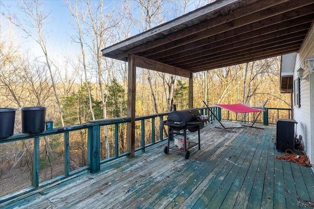 wooden deck with a grill