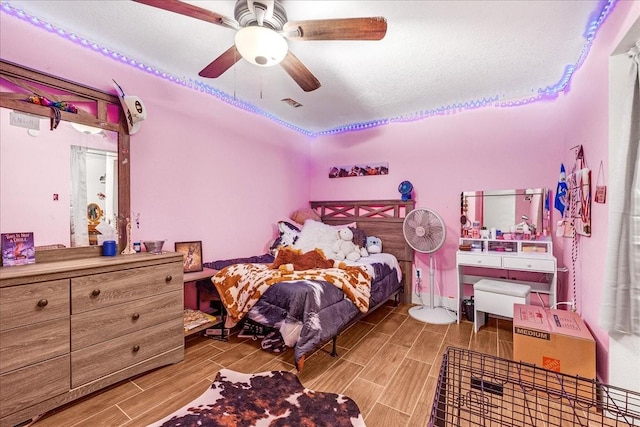 bedroom with a textured ceiling and ceiling fan