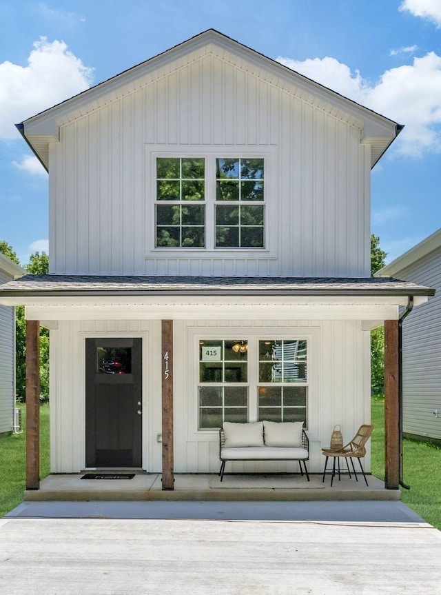 back of house featuring a porch