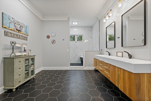 bathroom with a tile shower, vanity, and ornamental molding