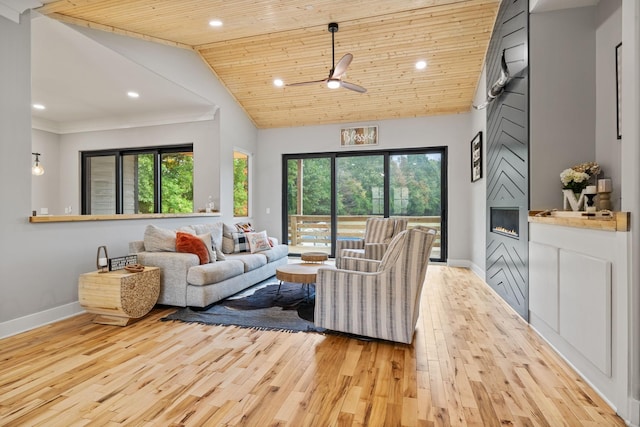 living room with light hardwood / wood-style floors, a healthy amount of sunlight, and wood ceiling