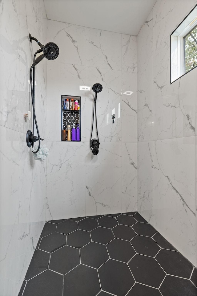 bathroom with a tile shower