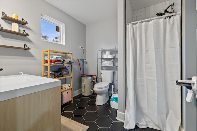 bathroom featuring toilet, a shower with curtain, tile patterned floors, and sink