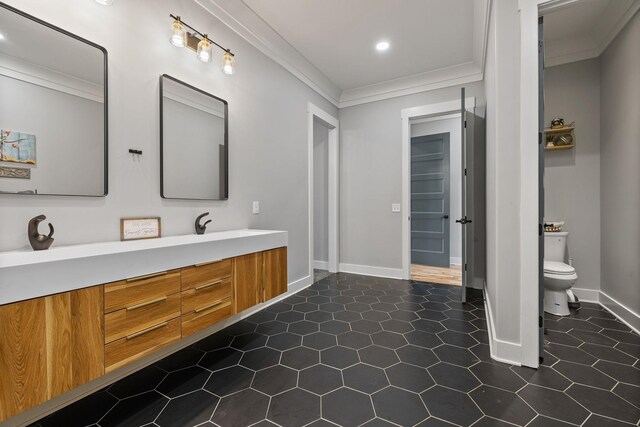 bathroom with vanity, toilet, and ornamental molding