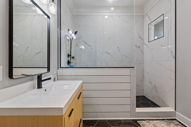 bathroom featuring tile patterned floors, vanity, and tiled shower