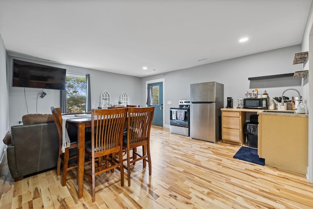 dining area featuring light wood-type flooring