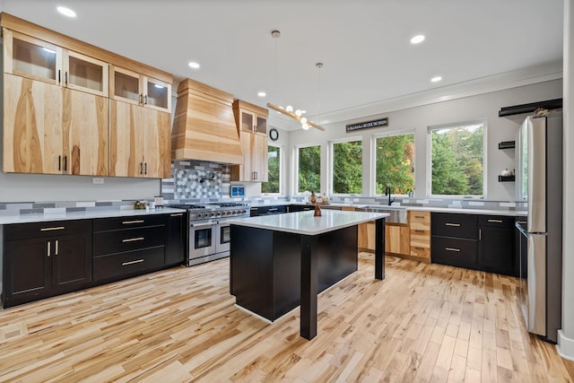 kitchen featuring a center island, premium range hood, hanging light fixtures, a breakfast bar area, and stainless steel appliances