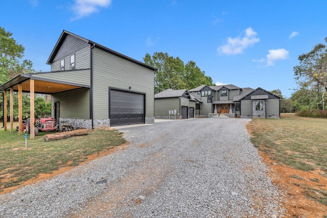 view of front of house featuring a front yard, a garage, and a carport